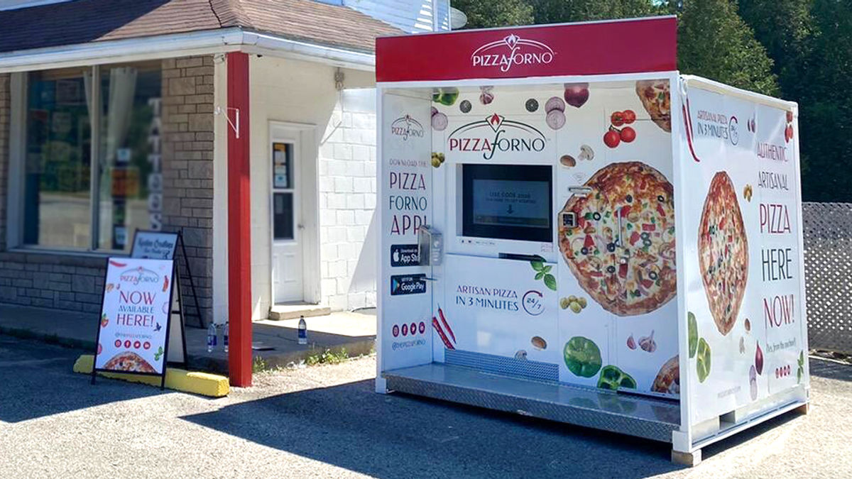 An outdoor pizza takeaway restaurant in Tobermory beside a general store.