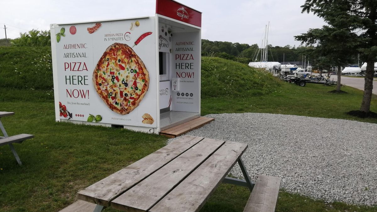 An outdoor PizzaForno automated pizza vending machine that is located at the side of the road at the Bayport Marina in Midland.