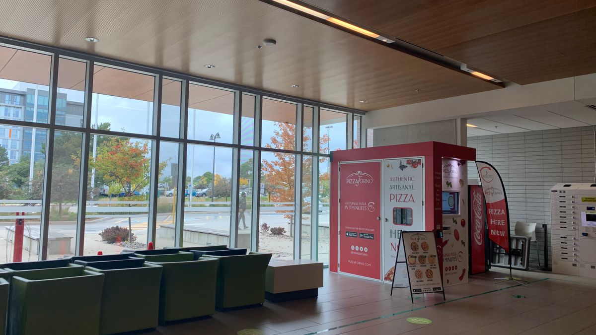 The inside of a building at Centennial College that has an indoor PizzaForno vending machine located inside.