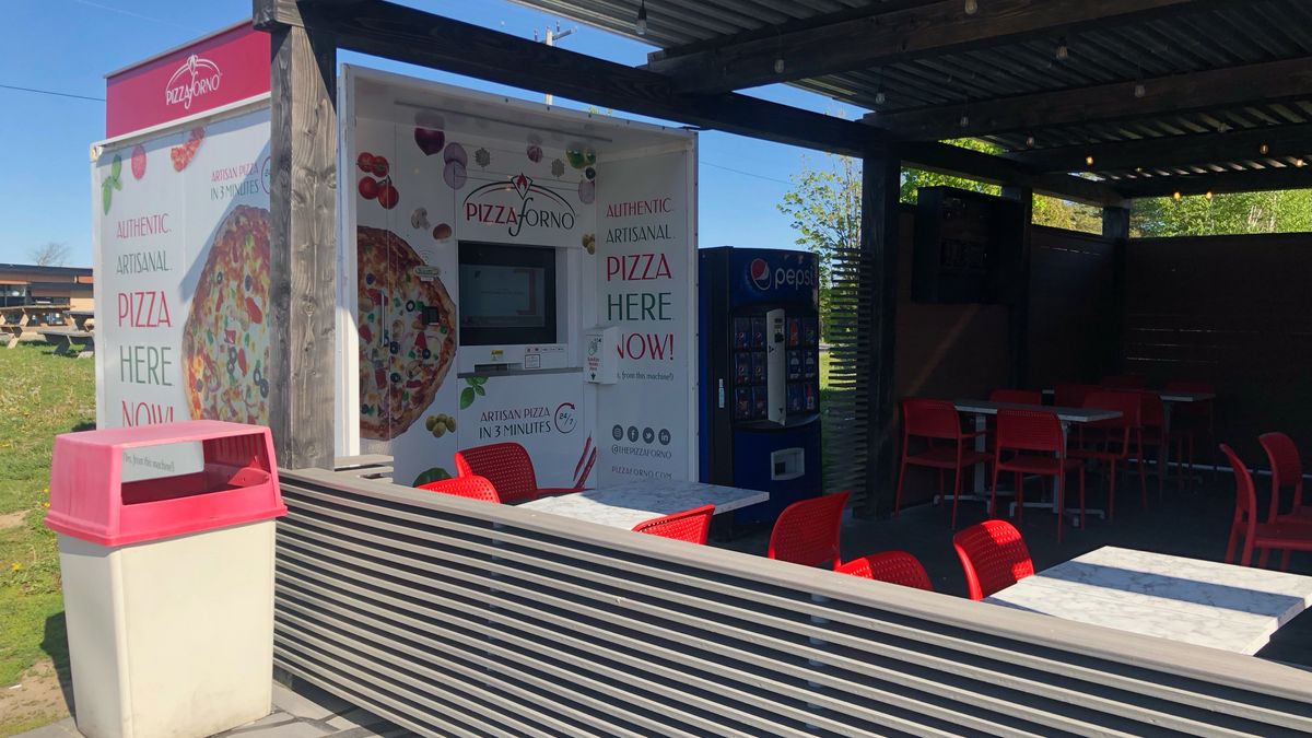 An outdoor patio that has a pizza vending machine built into the side of it in Mulmur.