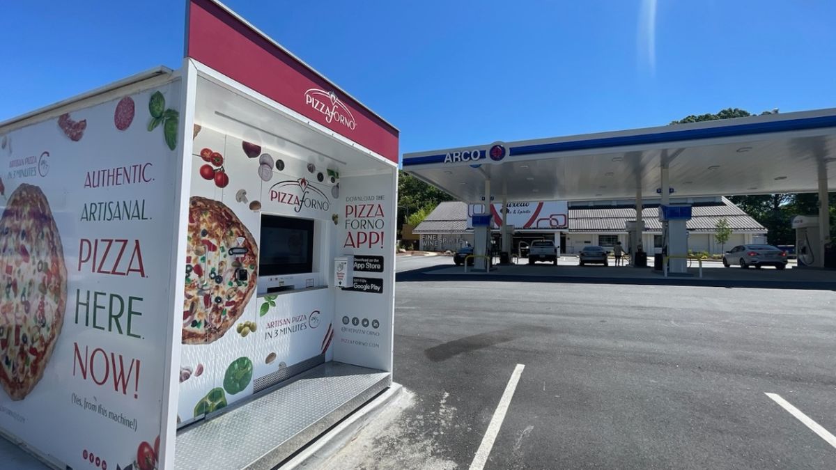 An automated pizza takeaway machine in Atlanta, Georgia. It is sitting in the gas station parking lot. 