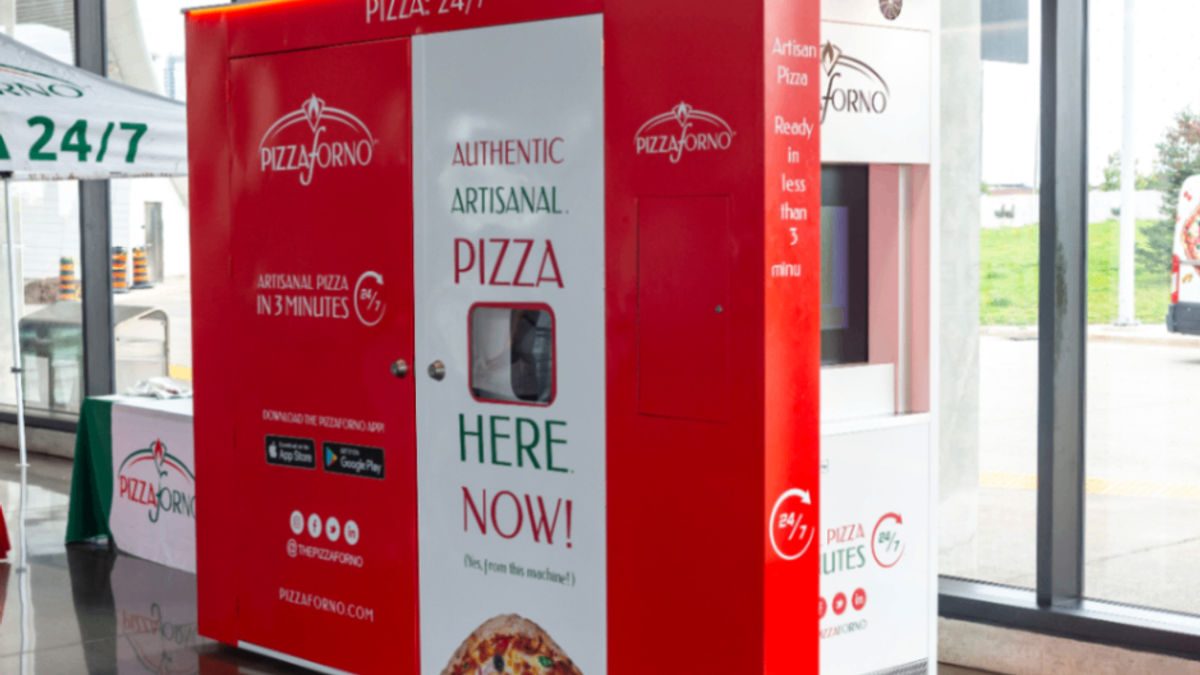 Red and white PizzaForno machine in front of big glass windows